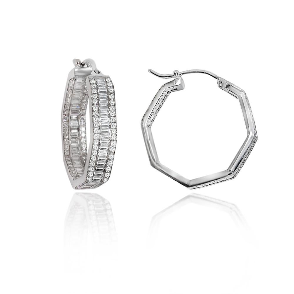 Elegant Art Deco style, these fascinating hoop earrings are in hexagon shape set with rows of sparkling baguette diamonds each row sided by two rows of round diamonds with total diamond weight of 2.75 carats set in 18 karat white gold.