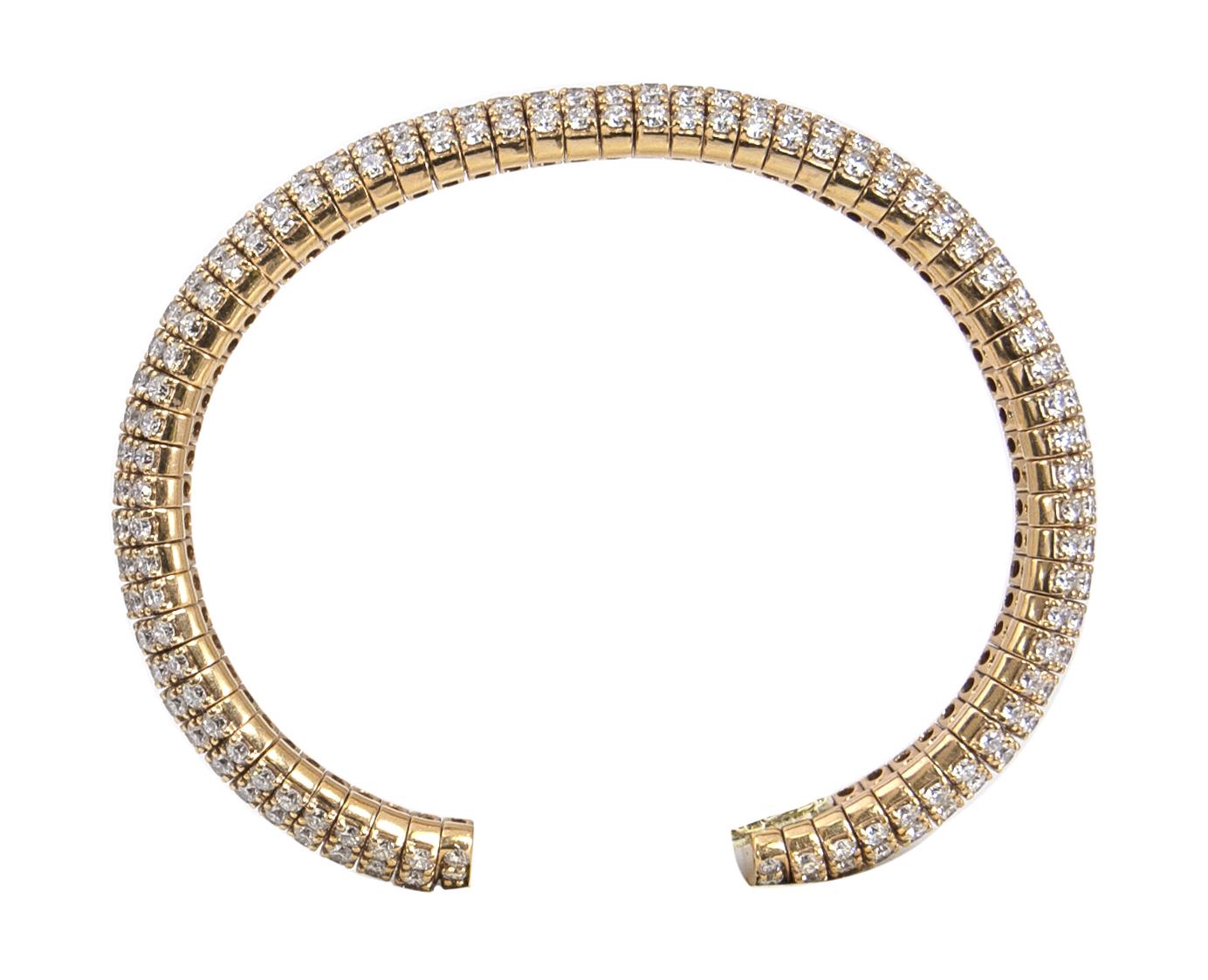 Beautiful open and flexible bangle with 12.40 carats of dazzling diamonds pave set in 18 karat yellow gold.