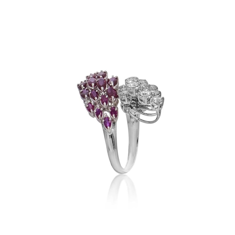 This absolutely fabulous ring features 15 marquise shape rubies in gradual sizes totaling 3.20 carats, plus 2.00 carats of brilliant diamonds of SI clarity and G-H color all set in 18 karat white gold to make a unique stunning  ring. This ring is
