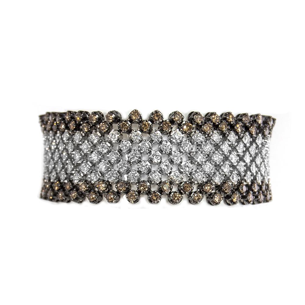 This most-magnificent diamond bracelet features 9.75 carats of white brilliant diamonds and 8.10 carats of sleek champagne color diamonds. It is very soft and has silky feeling on hand. It is 7 inches in length and 7/8 inches in width.
