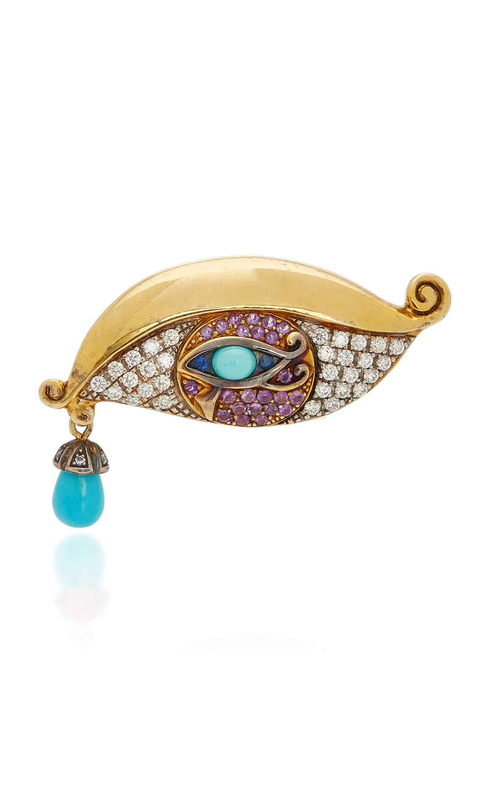 Limited edition of an eye ring in yellow 750/1000 (18K) gold and vermeil by Sylvie Corbelin. A turquoise is set as a moving tear in the corner of the eye. The turquoise is partly covered with a cap and diamonds.
You can see the 