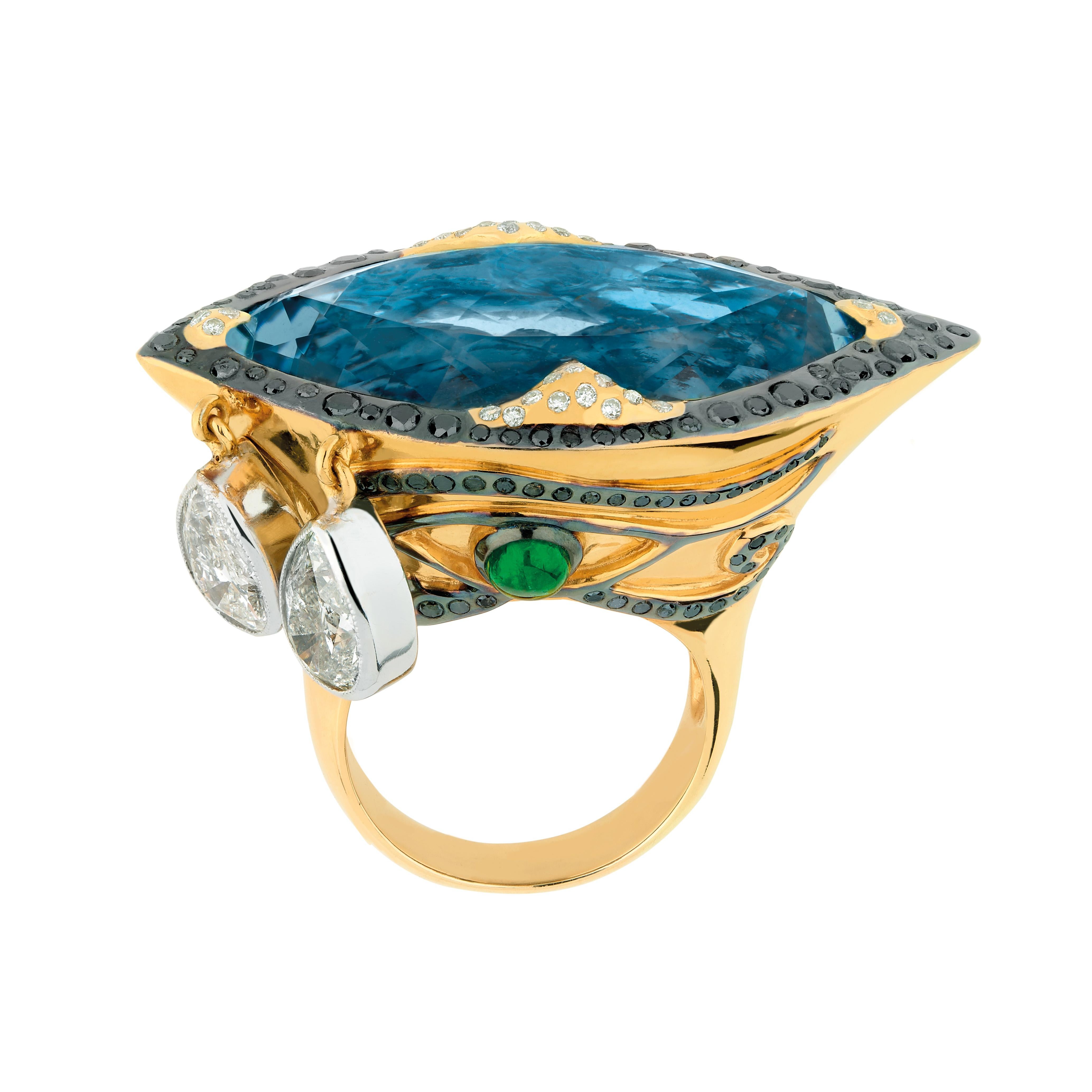 One of a kind eye shape ring in yellow 750/1000 gold (18K) and vermeil by Sylvie Corbelin.
A line of black diamonds surrounds an exceptionnal Santa Maria (Brazil) aquamarine.
On the side of the top of the mount, two drops of white diamonds are