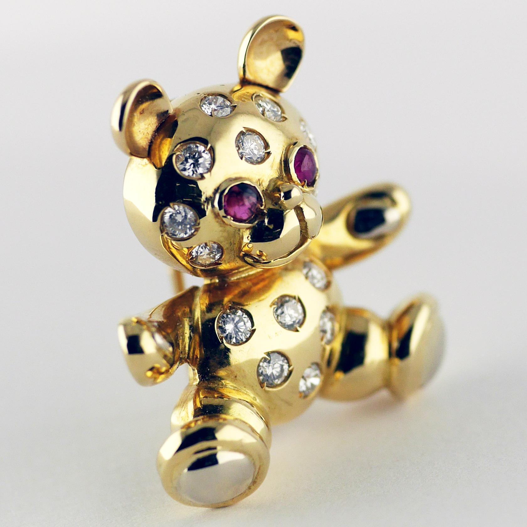 Charming Teddy Bear brooch with ruby eyes and diamond studded body dated circa 1960.

18ct yellow gold bear set with 2 extremely well matched cabochon cut rubies for eyes and 14 white full brilliant cut diamonds set into the body.

Total Ruby weight