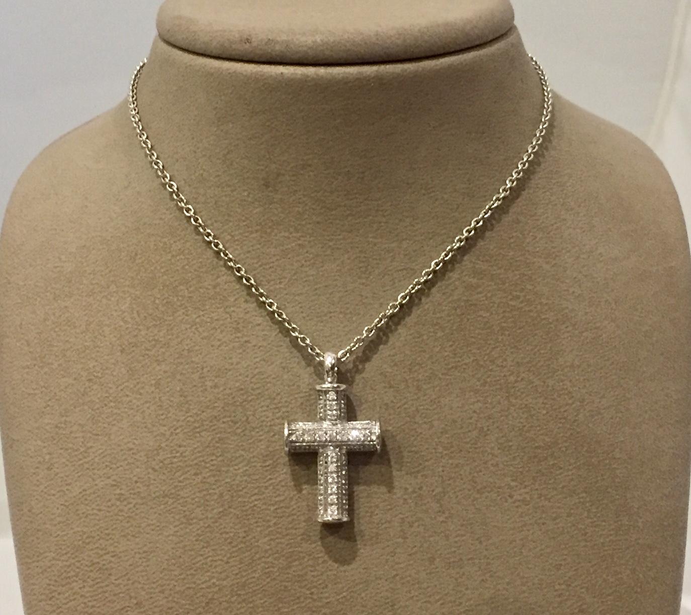 The pendant features a latin cross of cylindrical design, with three rows of brilliant-cut diamonds, in 18k white gold. Signed Bulgari. Comes with original chain, certificate and box. 
Original retail price was 5500 US $!
46 Brilliant cut Diamonds