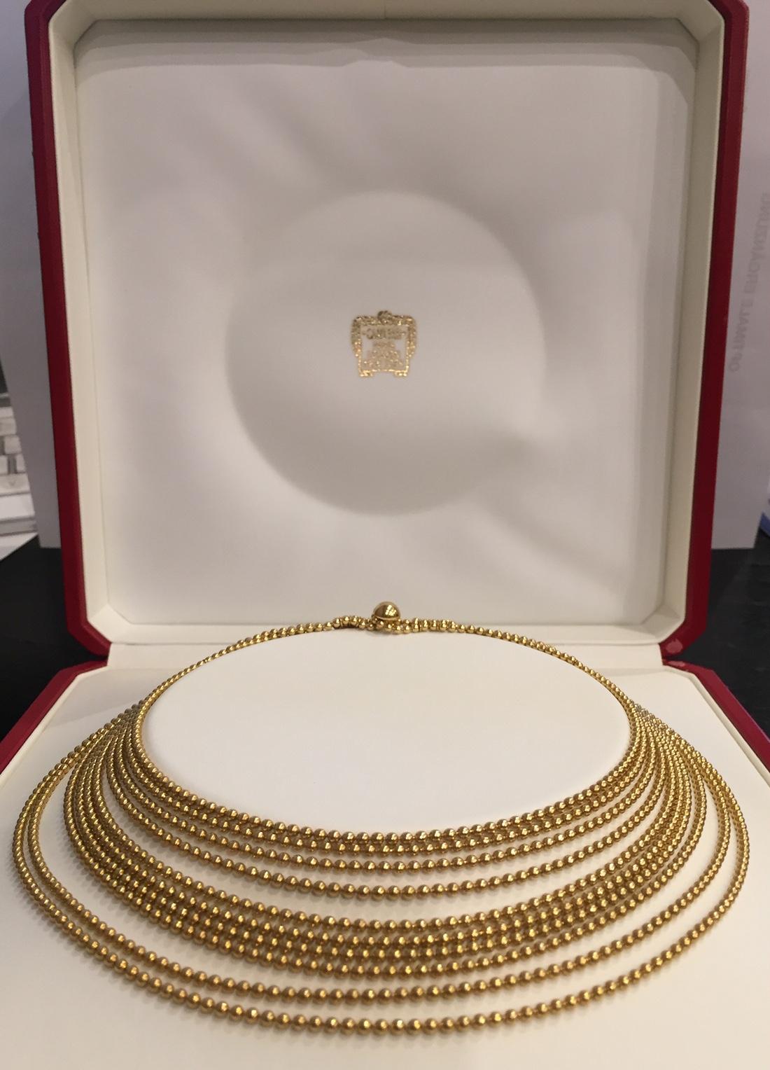 Cartier Draperie Necklace in 18 K, beautifully crafted in high polish yellow gold, the ten stranded gold bead necklace graduates in length from the top to the bottom strand. This estate signed designer Cartier draperie necklace is a timeless classic