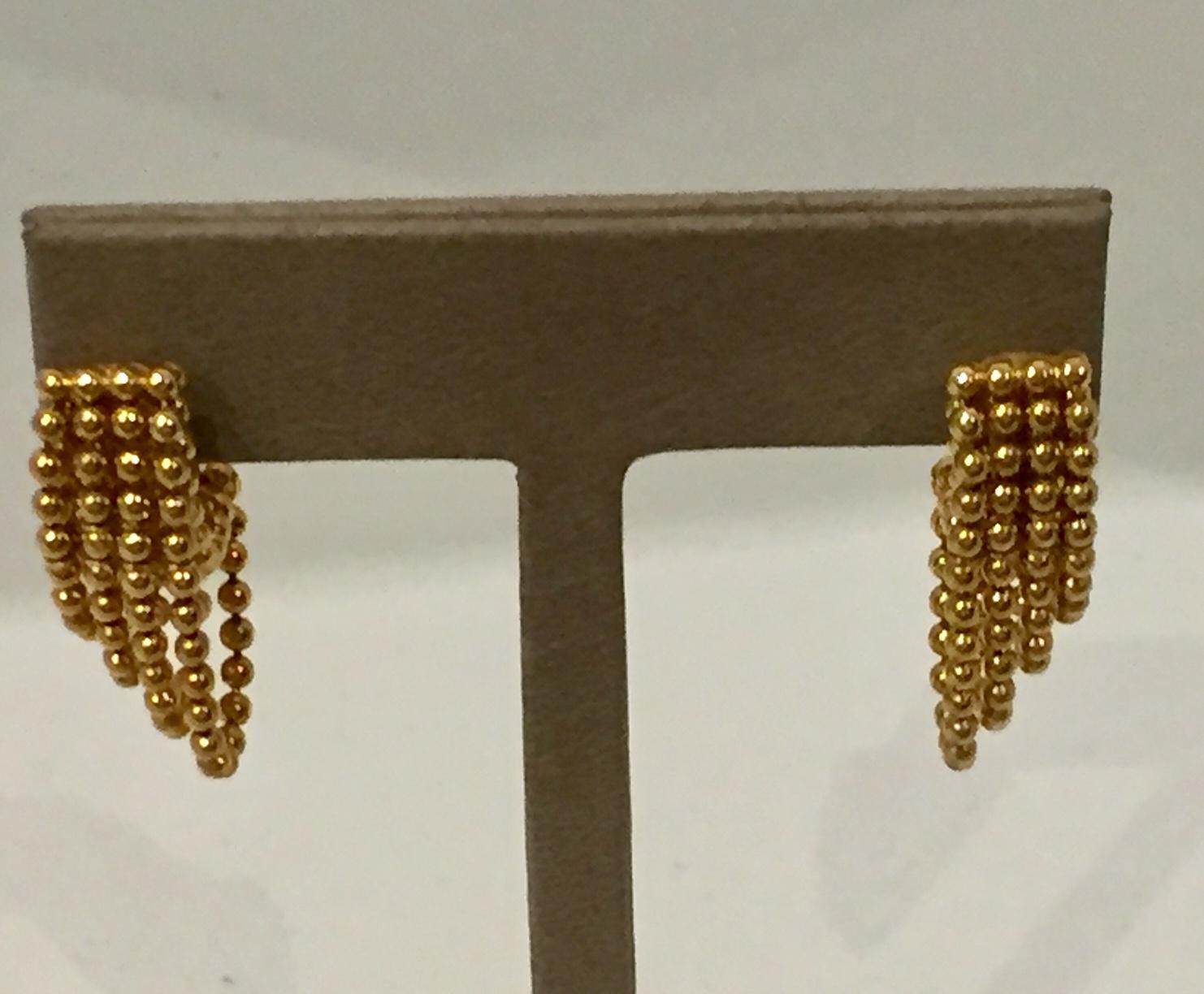 18K yellow gold Cartier Draperie earrings featuring metallic bead embellishments and omega back closures. 