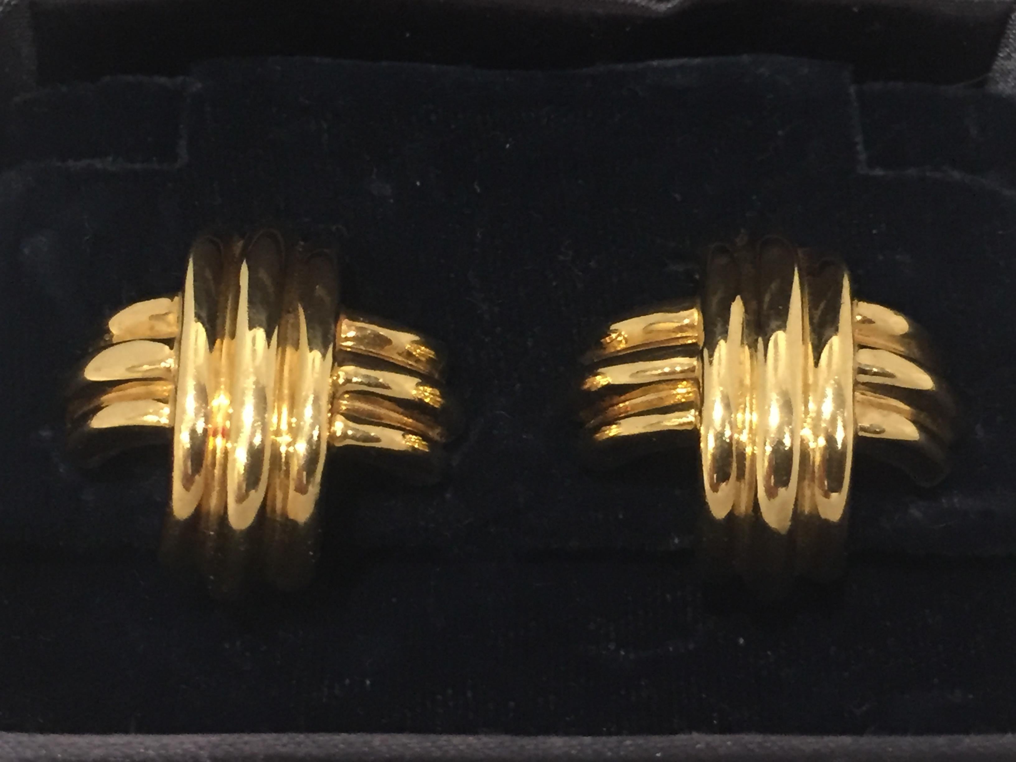 GOLD EAR CLIPS, TIFFANY. Yellow gold 750, 21.02 g. Signature large cross model. Casual, slightly convex ear clips/studs, with a crossed band motif, signed Tiffany & Co. 
Comes with original box. Matching necklace and ring available!
Masterfully