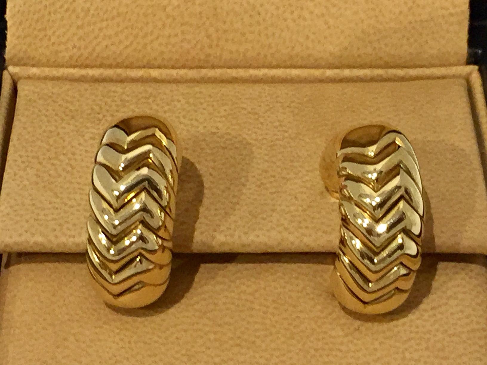 Each half hoop modelled as a line of chevron motifs, length approximately 25mm, signed Bulgari, clip fittings. Comes with the original box!