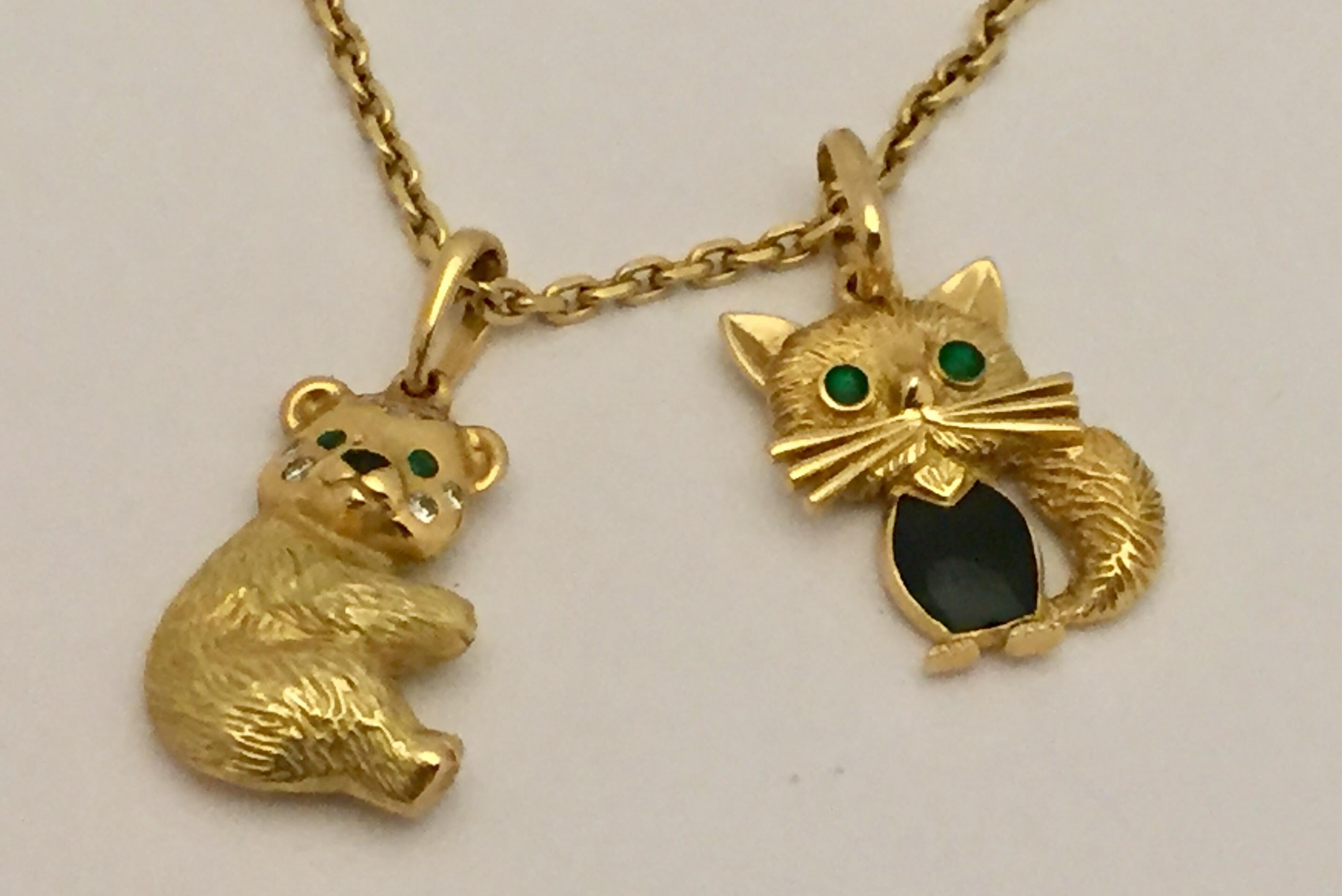 This rare and fabulous 2 Van Cleef & Arpels pendants feature the iconic chat malicieux  and bear design and are crafted in 18 K textured yellow gold and decorated with  emerald and enamel eyes accented with sparkling diamonds and enamel.  Made in