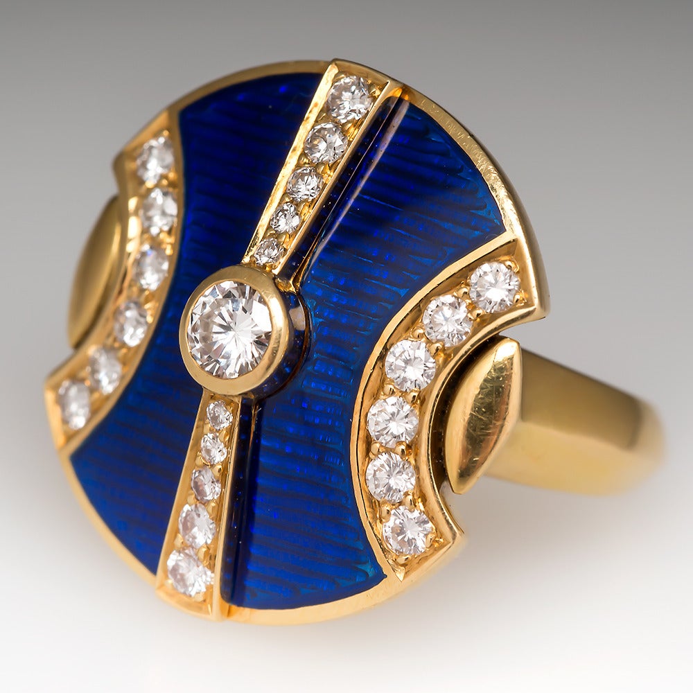 This Leo De Vroomen diamond, guilloche, and enamel ring is centered with a very high quality F / VVS2 round brilliant cut diamond weighing .25 carats. Guilloche is a decorative technique in which a very precise and intricate pattern is mechanically