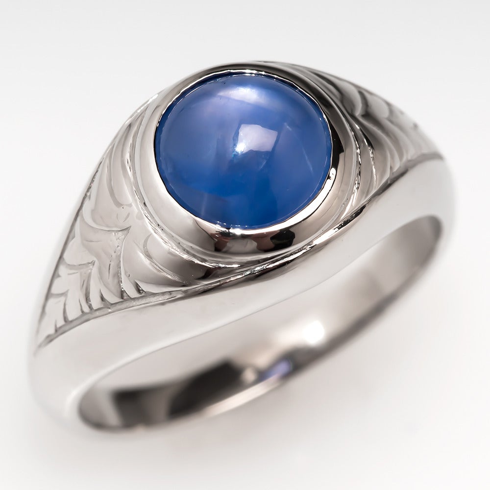 This ring features a bezel set 3.65 carat natural no heat star sapphire showing the coveted violetish-blue hue and a moderate 6-ray star with excellent movement.The star is very apparent in sunlight or direct light, please contact us for a star
