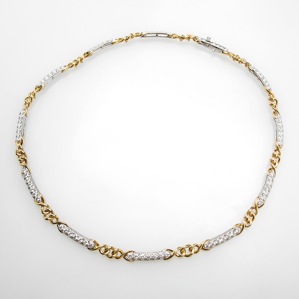 This striking Tiffany & Co diamond line necklace is artfully crafted of solid platinum and 18k yellow gold. The classic necklace is in excellent condition, measures 16.5