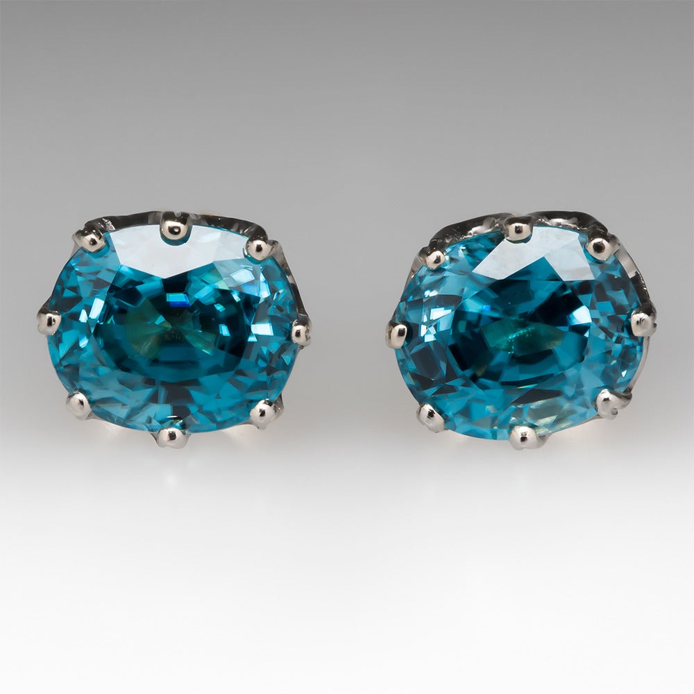 These spectacular earrings are crafted of solid 18k yellow gold with platinum crown tops. These earrings feature gorgeous blue zircon gemstones and the crown settings are incredible. The zircons total 6.13 carats and have amazing color. These