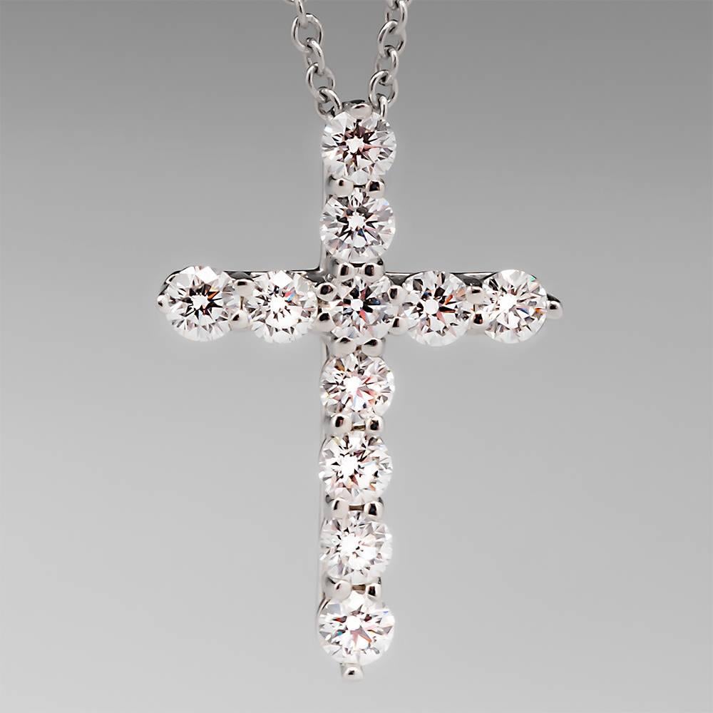 This gorgeous Tiffany small cross pendant necklace features bright sparkling diamonds and is crafted of solid platinum. The cross measures just under 3/4