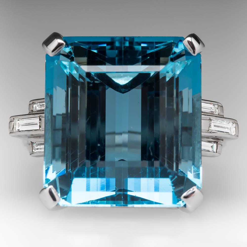This amazing vintage ring dates from the 1950's and features a massive 27.16 carat aquamarine center stone. The aqua is accented elegantly with flush set baguette diamonds and the ring is crafted of solid platinum. The color of the aqua is fantastic