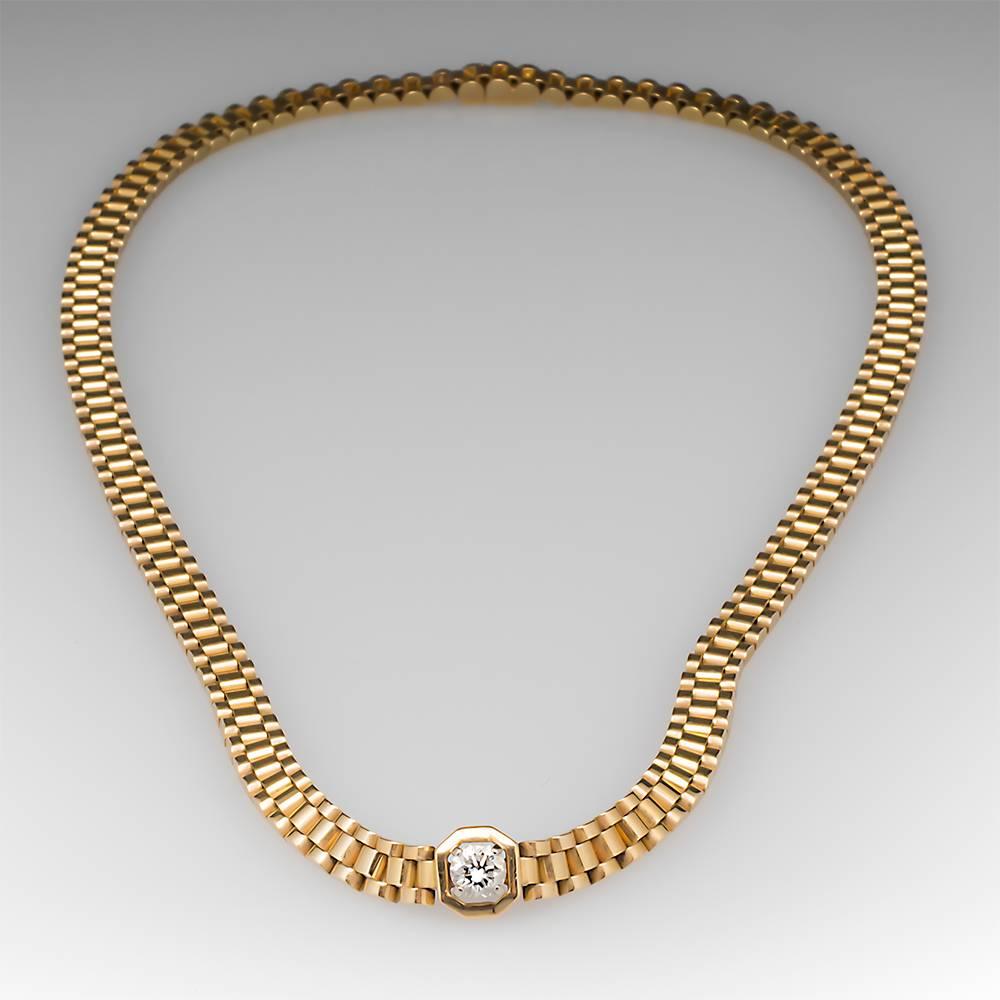 This incredible necklace features a Rolex Style link design with a lovely .70 carat round brilliant diamond solitaire at the center. The necklace measures 18