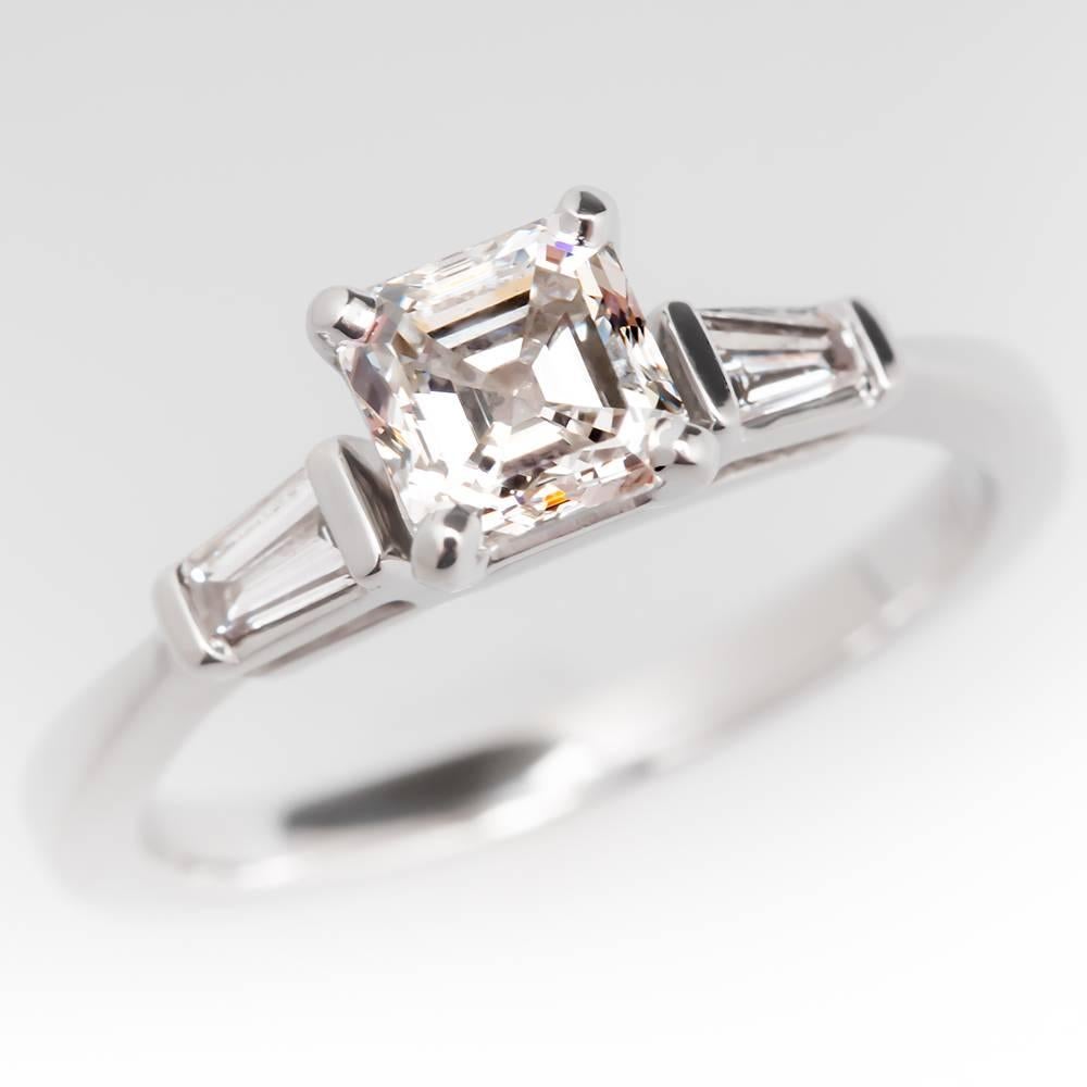 This gorgeous ring features a GIA certified .76 carat asscher cut diamond center stone that grades a gorgeous E in color and VVS2 in clarity. The ring is accented with tapered baguette diamonds and is crafted of solid 14k white gold. It is in