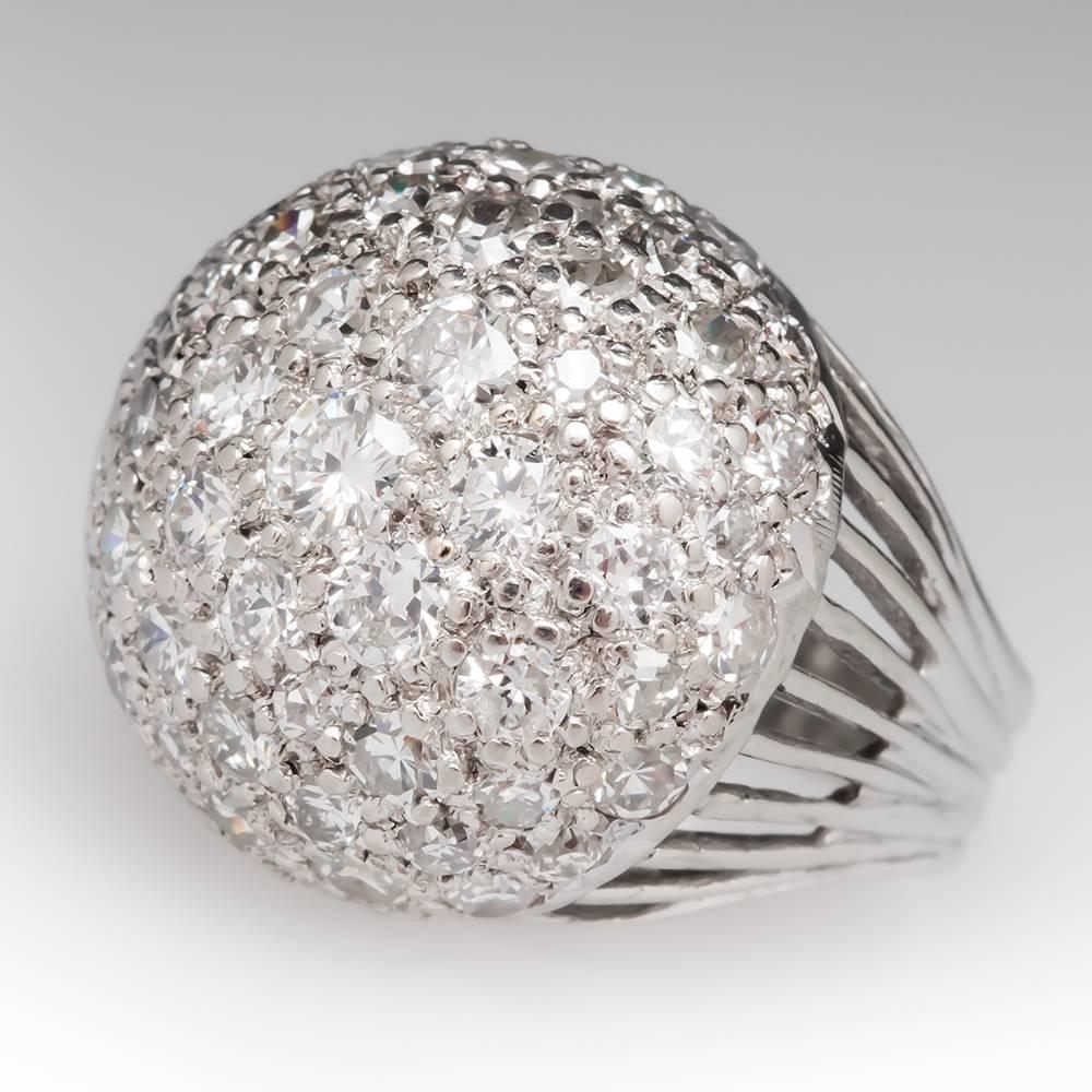 This vintage dome cocktail ring features a 3 total carat cluster of round diamonds that sit high on the finger. The ring is crafted of solid 14k white gold and is currently a size 5. It can be resized prior to shipping.