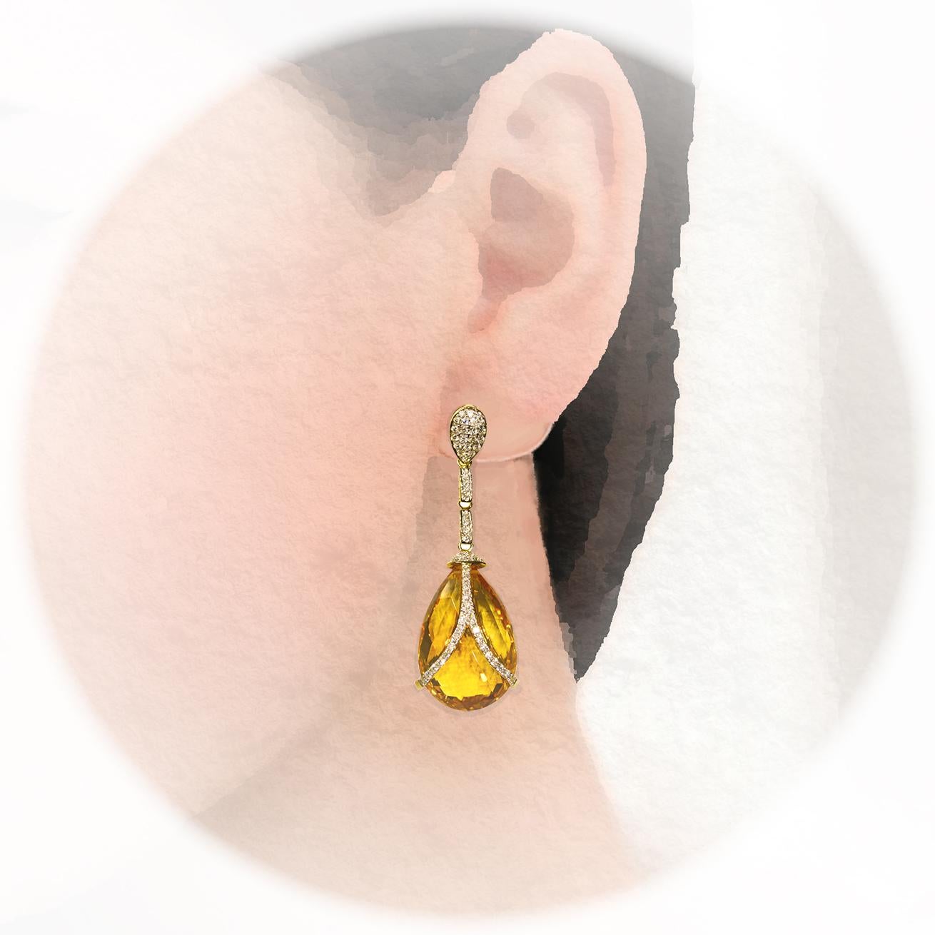Statement piece. Lively yellow, pear shape, checkered pattern faceted 40.98 carats citrine dangling earrings, contemporary design, accented with sparkling round brilliant cut diamonds, handcrafted in 14 karat yellow gold with screw back post.  These