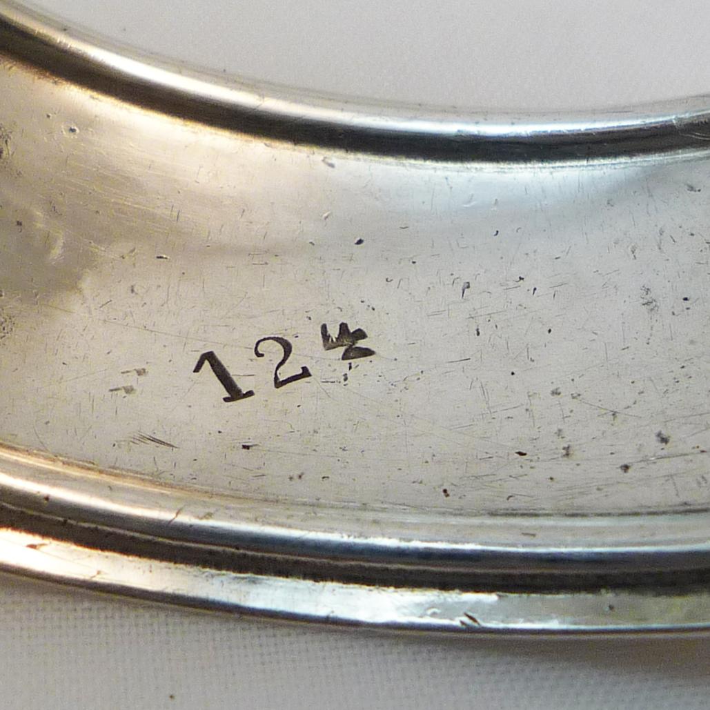 Bracelet Silver

Bracelet in the shape of a napkin ring with a engraved fish motif

8oo silver, additional hallmark 124

D: approx. 6 cm wide, since open

B: 2,5 cm

Germany around 1960
