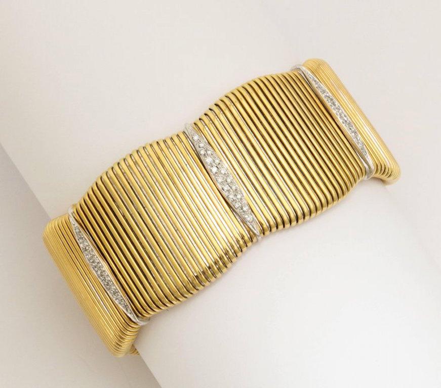 A wonderful modernist French gold cuff. A flexible body in 18kt gold with white gold and diamond cameos.
