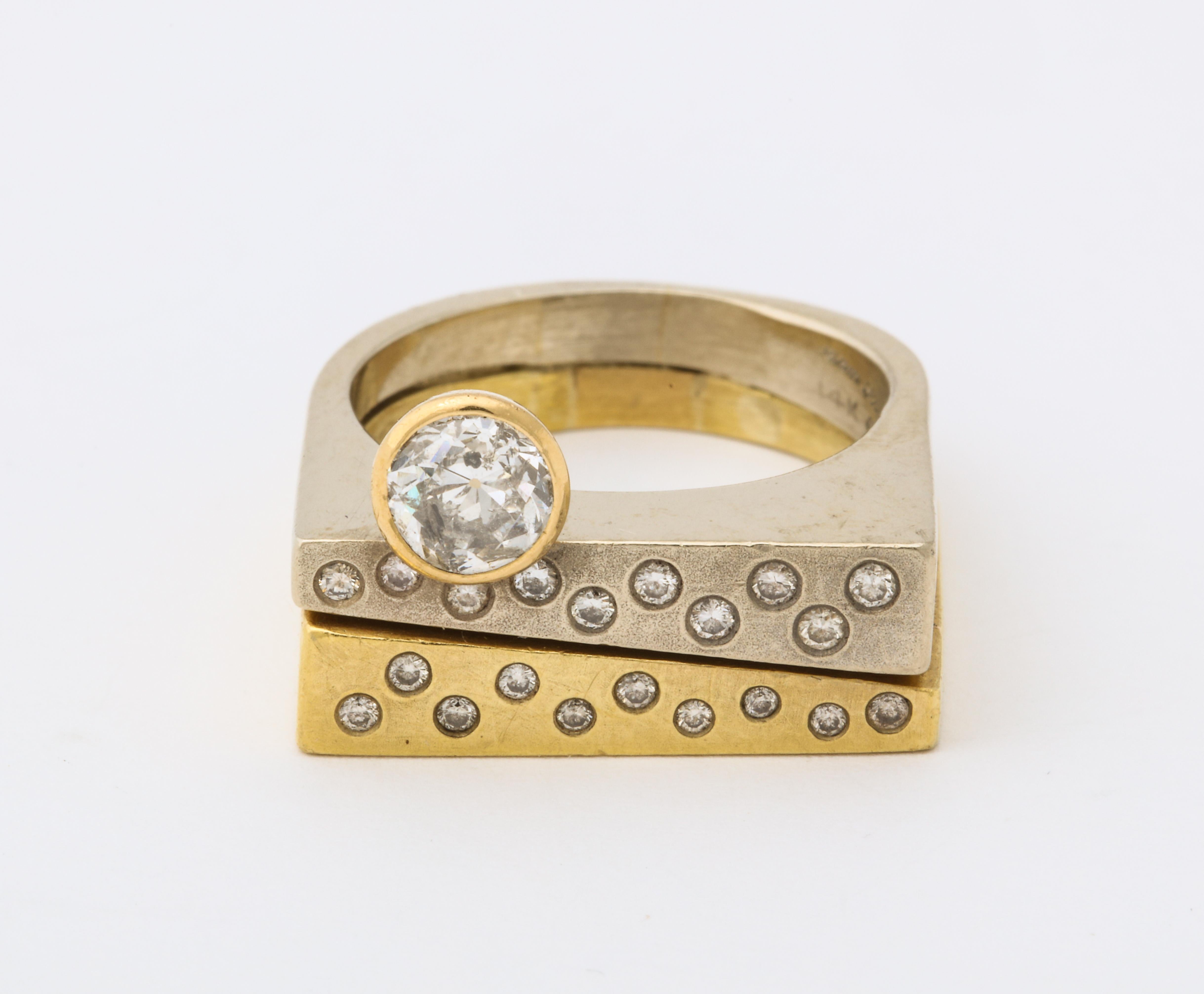 A wonderful modernist two color 18 k gold ring with a brilliant diamond atop of rows of pave diamonds