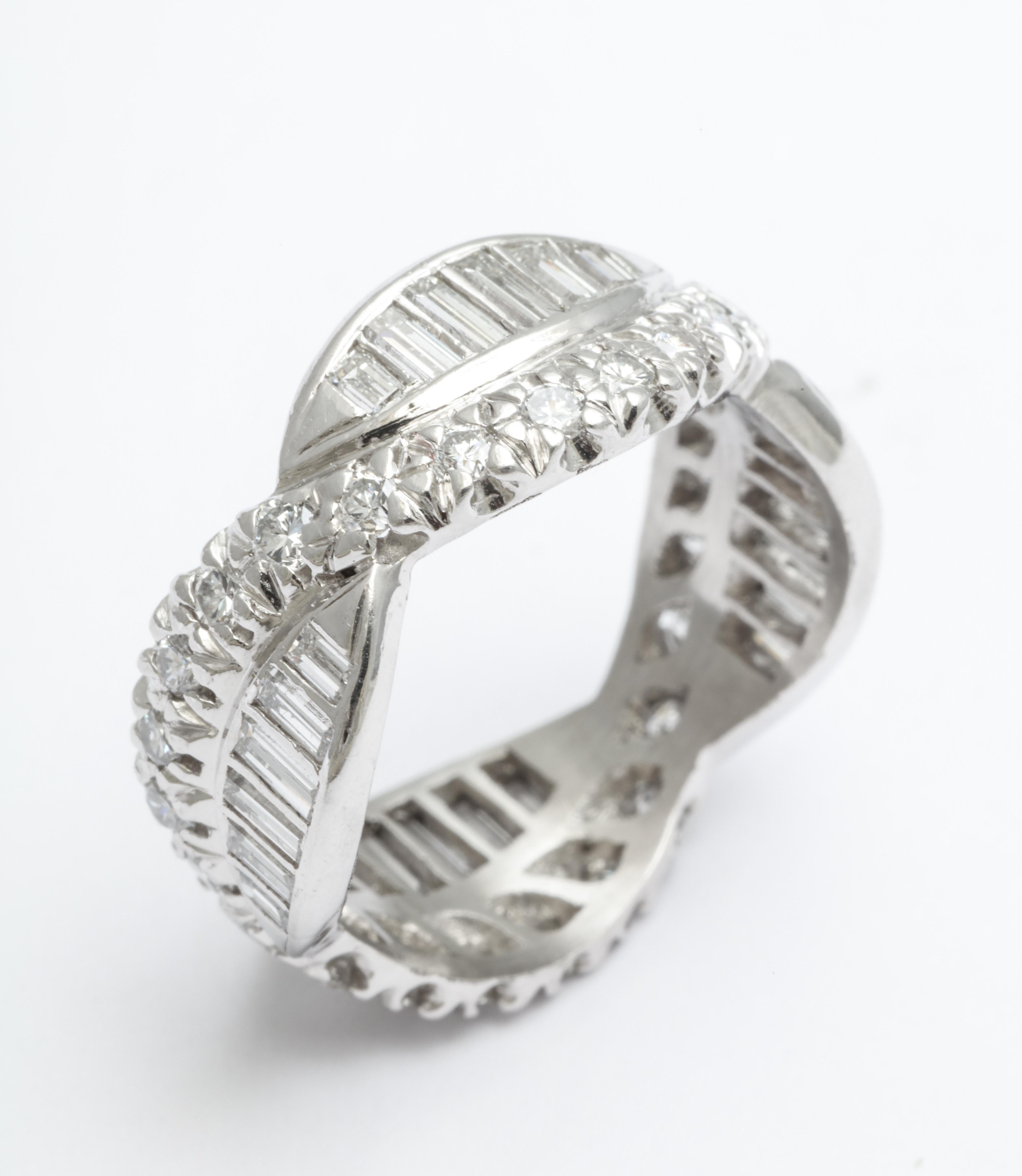 An elegant period Art Deco eternity band woven form with diamond baguettes and chips set in platinum. Measures: Its ring size is 5 3/4.