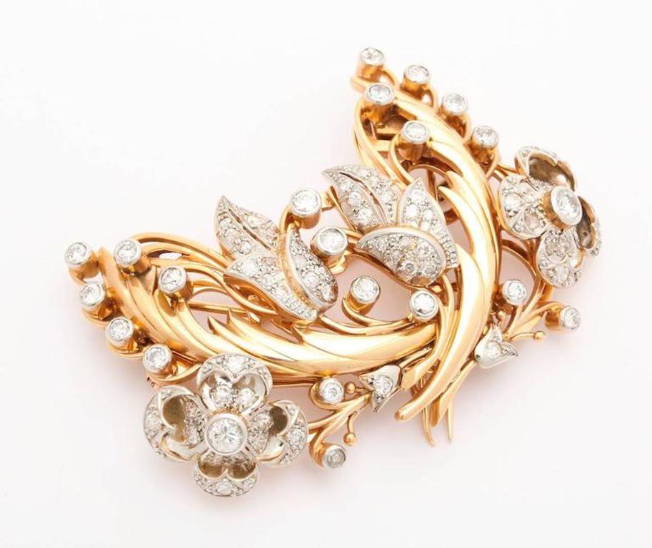 An exceptional 18-karat gold brooch that can be worn together as pin or separated as a pair of clips. Mounted onto an exquisite frame which can be worn as a brooch.
