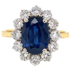 Bague de fiançailles en or blanc et jaune 18 carats, sertie d'un saphir bleu et d'un halo de diamants