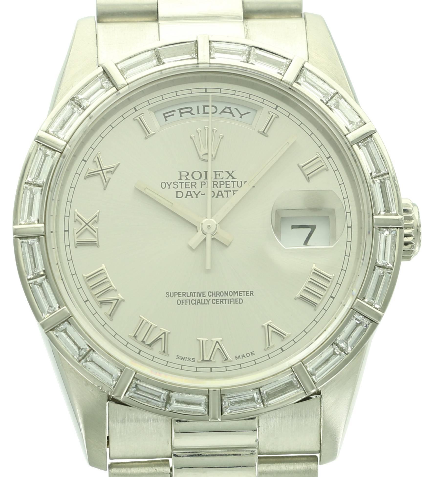 This beautiful Platinum and Diamond Rolex Day-Date features roman numeral markers, 24 baguette diamond bezel and comes with its original papers. 
