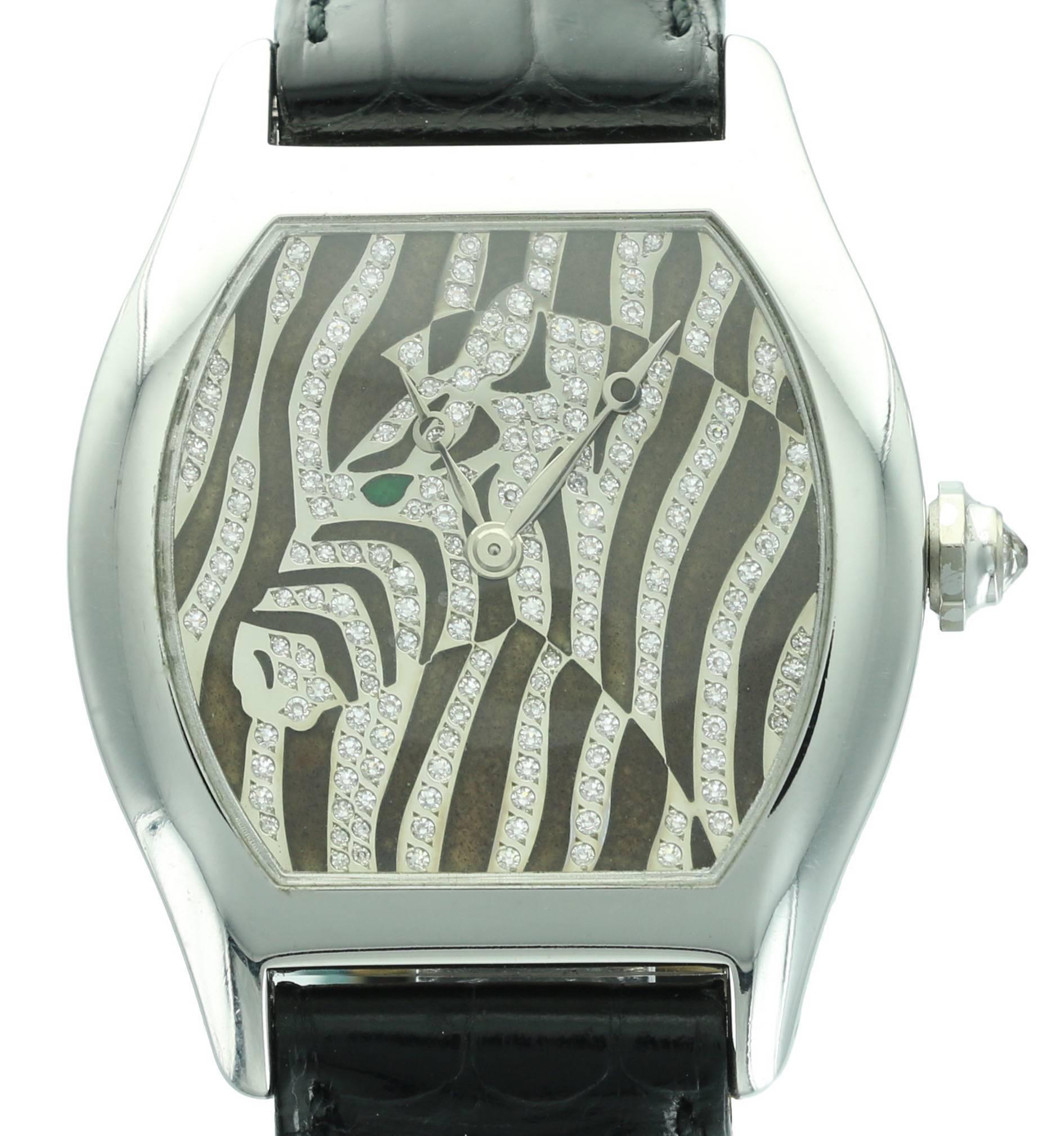 Perfect for any animal lover, this extremely rare, white gold Cartier Tortue shaped watch features a beautiful diamond  Zebra with an emerald eye. This watch was produced in a limited series of 20 watches and is numbers 15 of the 20. 