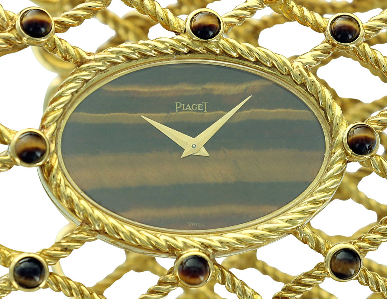 This truly spectacular ladies Piaget bangle watch features a wide yellow gold, intertwined rope bangle with round Tiger's Eye accents and a beautiful Tiger's Eye dial watch. Stylish, elegant and very wearable, this watch is both a fine piece of