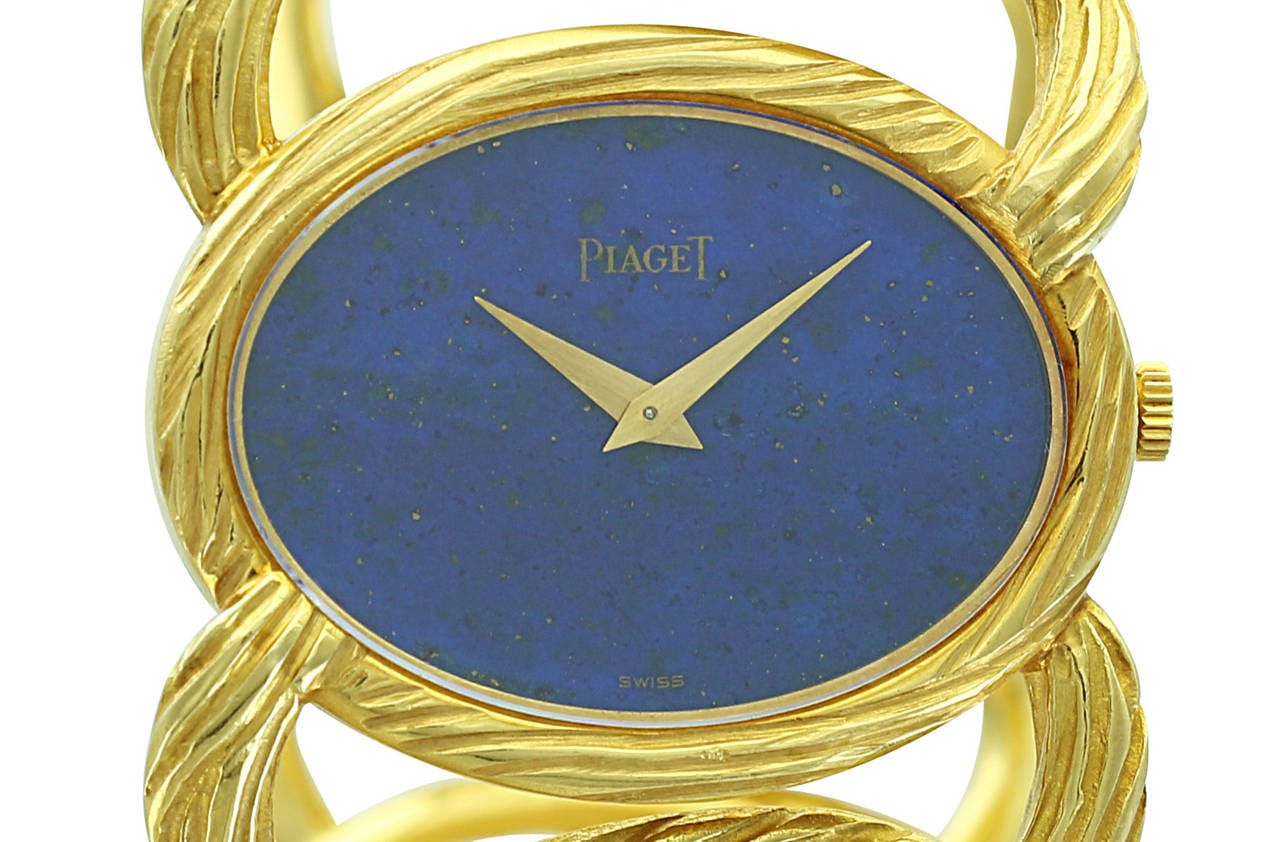 This lady's Piaget bracelet watch features an oval, twisted-rope 18k yellow gold band and beautiful lapis lazuli dial. The watch is simple, elegant and a wonderful example of Piaget's classic style.