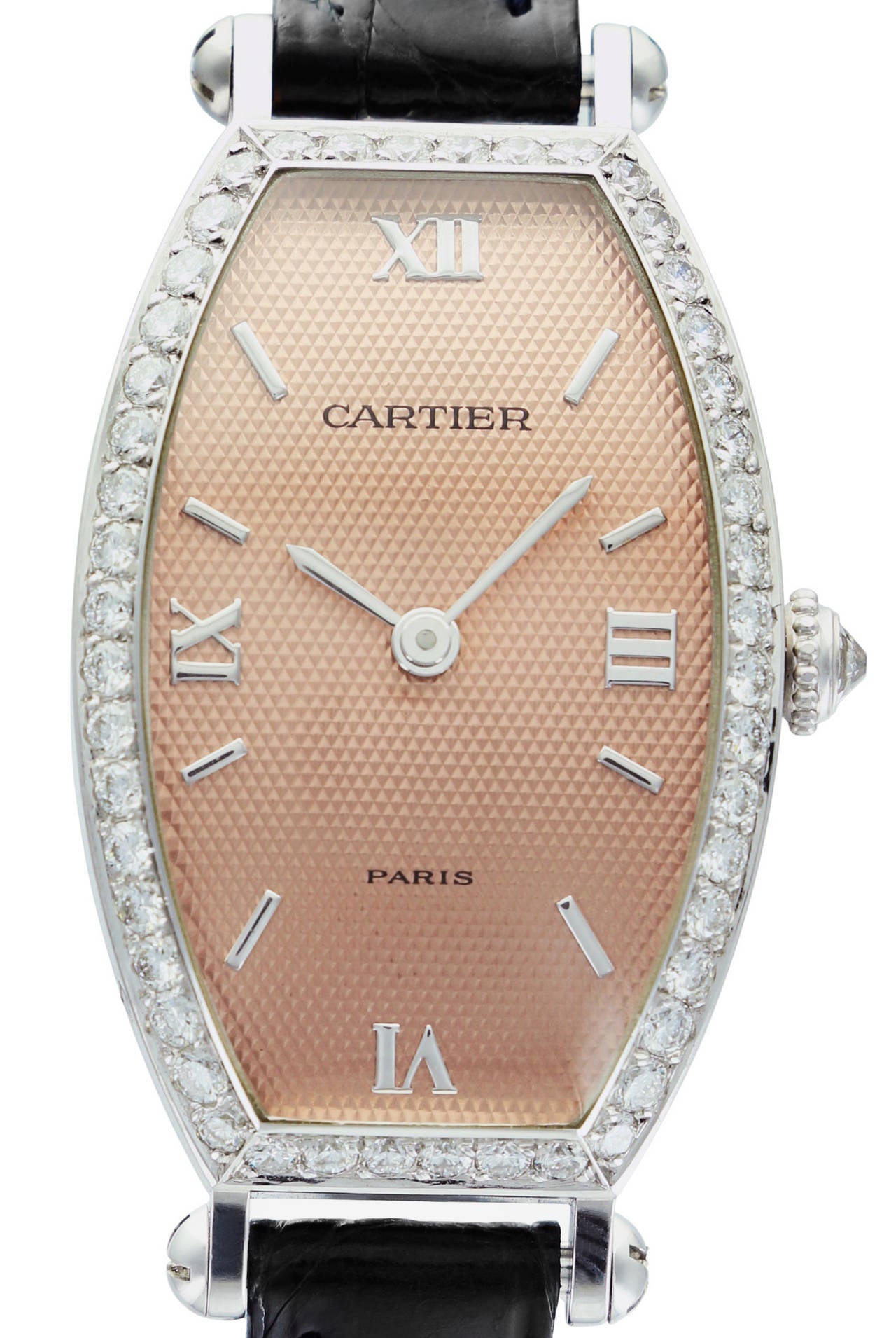 This very rare Cartier ladies watch has a beautiful salmon colored dial, white gold case and diamond bezel. It is truly an elegant masterpiece from a classic brand.