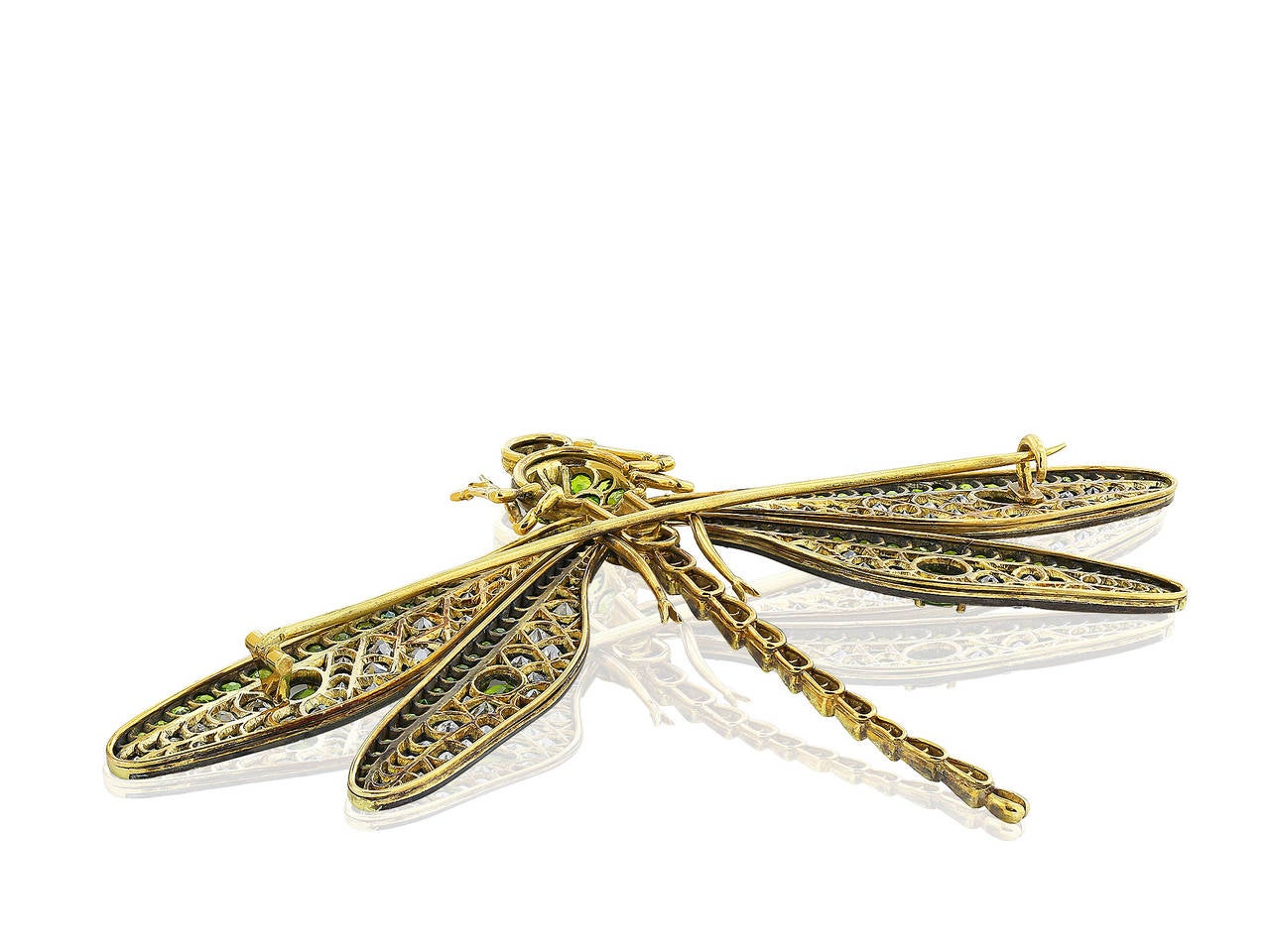 Sterling silver on 18 karat yellow gold vintage style dragonfly pin set with Old European cut diamonds and demantoid garnet accents with ruby eyes.