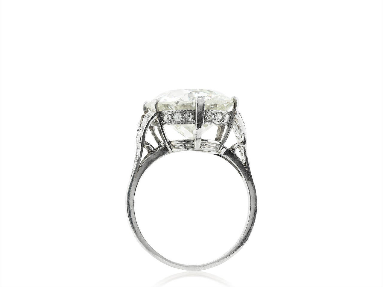 Platinum style solitaire ring consisting of 1 Old European cut diamond weighing 7.56 carats having a color and clarity of K/SI2, measuring 12.99 - 12.84 x 7.08mm with EGL certificate US910427912D, the stone is set with Old European cut diamond