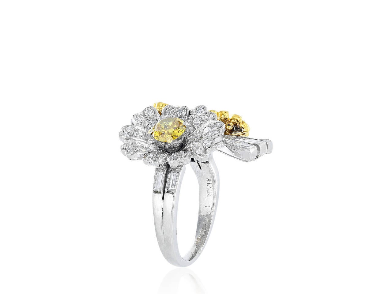 Platinum and 18 yellow gold floral motif ring consisting of 3 prong set full cut diamonds 2 white and one yellow canary having an estimated total weight of 1.03 carats and pave set single cut white and yellow diamonds having an estimated total