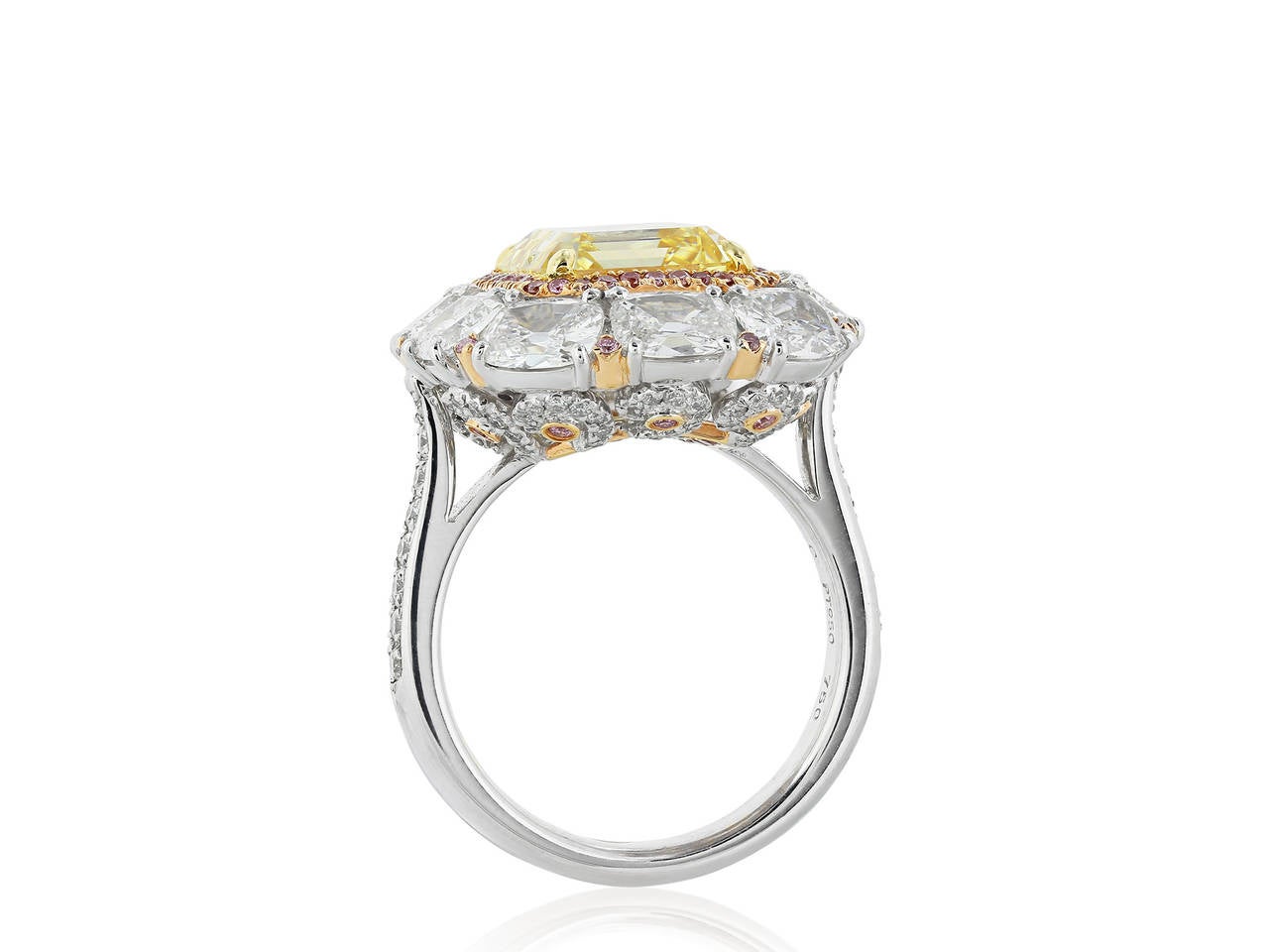 Platinum and 18 karat rose gold cluster style ring consisting of one emerald cut natural canary diamond weighing 5.08 carats, measuring 9.86 x 8.70 x 6.17 mm, having a color and clarity of Fancy Intense Yellow/ VS2 with GIA Report 5141643187,
