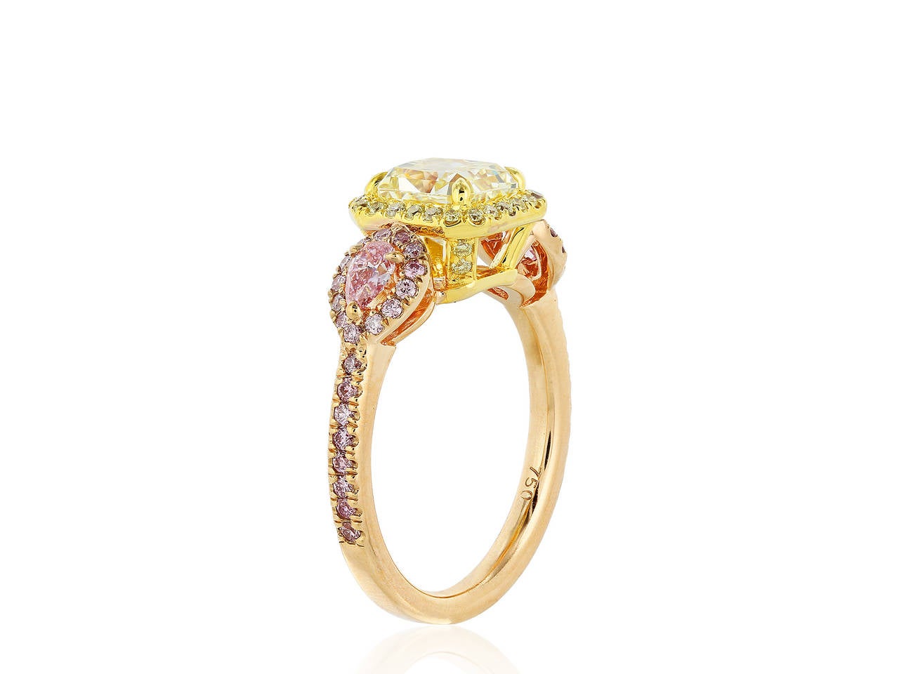 18 karat two tone rose and yellow gold three stone ring consisting of one radiant cut diamond weighing 1.67 carats , measuring 6.65 x 6.14 x 4.50 mm, having a color and clarity of Fancy Yellow/ VVS2 wigh GIA Report 6167636991 surrounded by a halo of