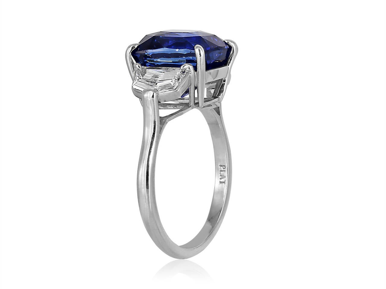 Platinum 3 stone ring consisting of 1 cushion cut sapphire weighing 6.19 carats, measuring 10.17 x 8.52 x 7.66mm with GIA certificate #12960342, the center stone is flanked by 2 step cut half moon shaped diamonds having a total weight of .71 carats.