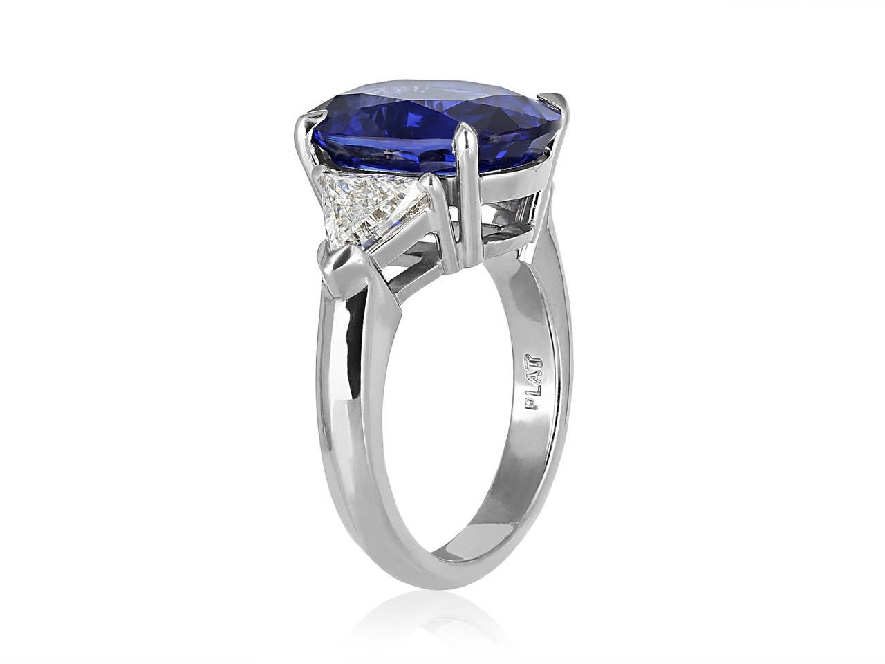 Platinum custom made 3 stone ring consisting of 1 oval shaped sapphire weighing 8.25 carats, measuring 13.85 x 10.34 x 6.33mm with AGL certificate CS 57047 stating origin as Ceylon. The center stone is flanked by 2 trilliant cut diamonds having a