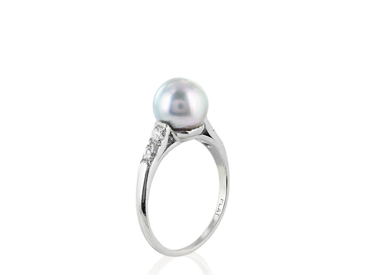 Platinum vintage ring consisting of one 8.80 mm gray pearl the pearl is flanked by 2 Old European cut diamond accents on each side.