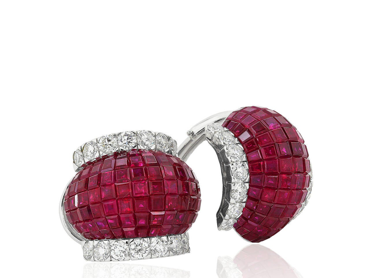 18 karat white gold clip earrings consisting of 183 invisible set rubies having a total weight 19.63 carats set with 28 round brilliant cut diamonds having a total weight of 2.99 carats.