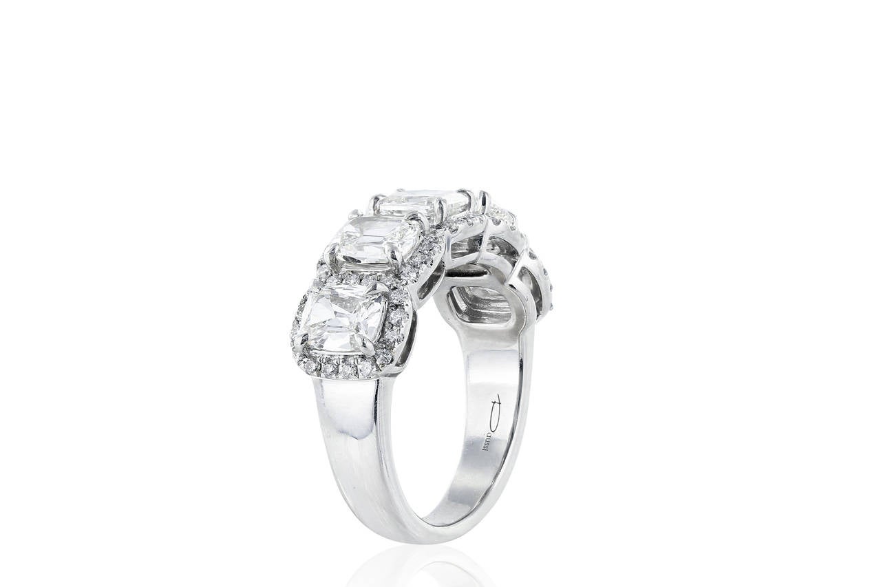 Lady's cushion cut diamond ring set in platinum containing 5 cushion cut diamonds having a total weight of 2.15 carats. Each cushion cut diamond is surrounded by a single row of round brilliant cut diamonds having a total weight of .35 carats.