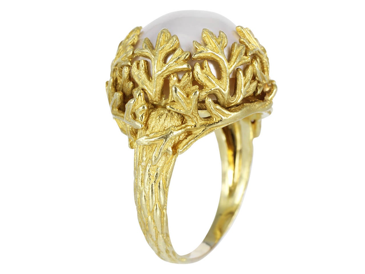 18 karat yellow gold ring with a branch design motif and a mabe pearl set in textured branches done in a matte and polished finish.