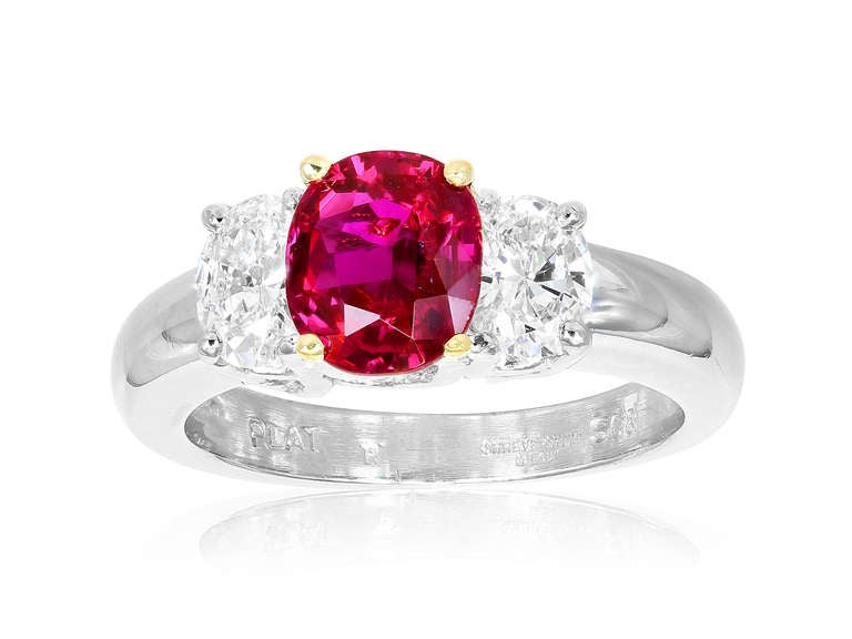 Platinum and 18 karat yellow gold 3 stone ring consisting of 1 oval shape natural Burma ruby weighing 1.84 carats with AGL certificate CS 53941 stating No Heat, the center stone is flanked by 2 oval shaped diamonds having a total weight of