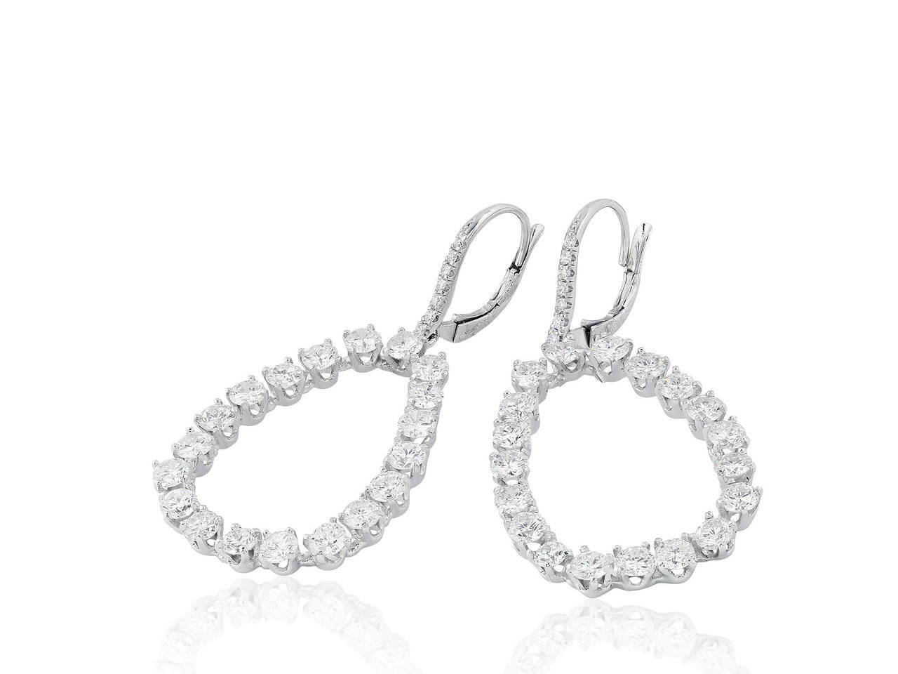 Platinum tear drop shape earrings set with 38 round brilliant cut diamonds having a total weight of 5.80 carats total weight and approximate color and clarity of E/VS2.