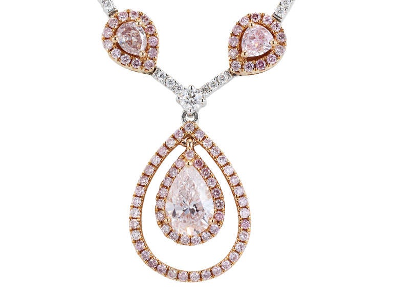Two tone 18 karat pink and white gold semi flexible necklace consisting of 23 pear shape natural pink diamonds having a total weight of 4.67 carats set with 2.44 carats total weight of round brilliant cut natural pink diamonds and 2.24 carats total