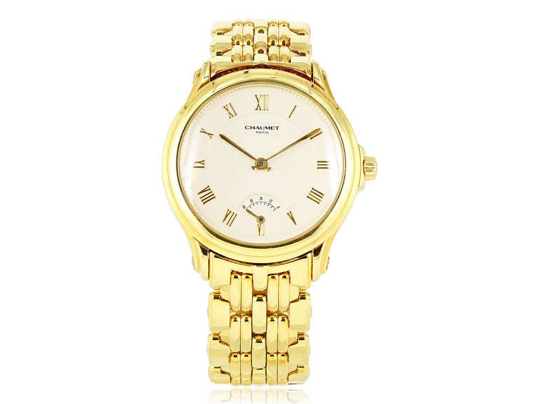 Chaumet Lady's 18k yellow gold wristwatch with power reserve, automatic movement, textured cream-color dial, with 18k yellow gold Chaumet link bracelet. Almost 5 oz gold
