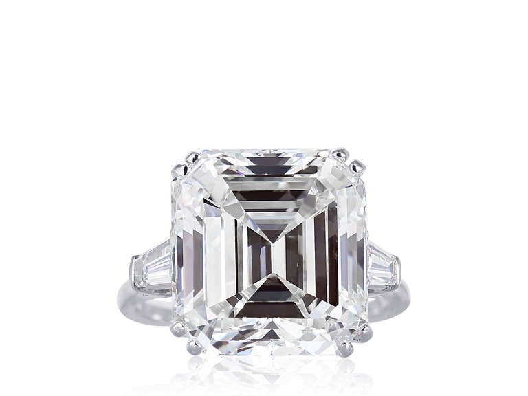 Platinum vintage ring consisting of 1 square emerald cut diamond weighing 13.24 carats having a color and clarity of J/SI1, measuring 14.15 x 13.18 x 8.29mm with GIA certificate 5101878041 the center stone is flanked by 2 tapered baguette diamond